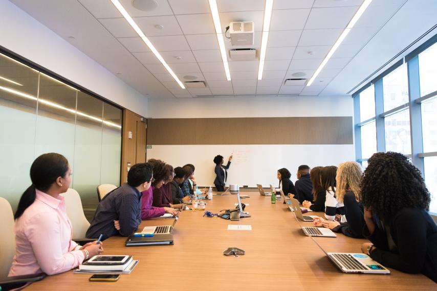 group of people meeting around a boardroom table