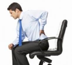 Man experiencing back pain on an office chair from lack of lumbar support