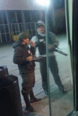  armed guards in bullet proof vests at a gas station
