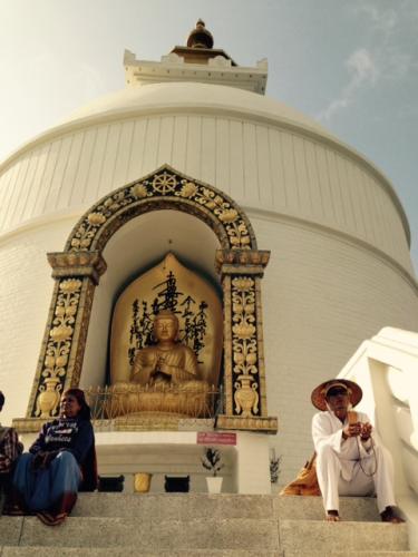 golden Buddha statue at white tower