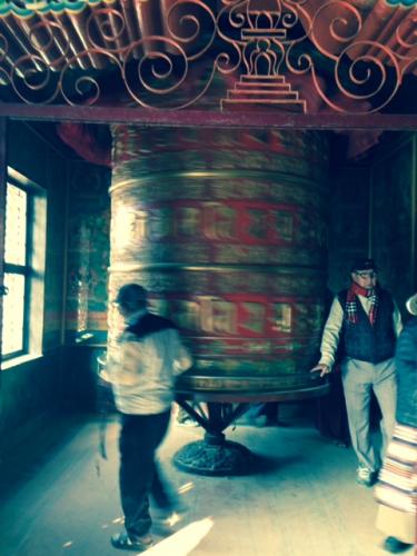 Two men walking around a stupa in a temple