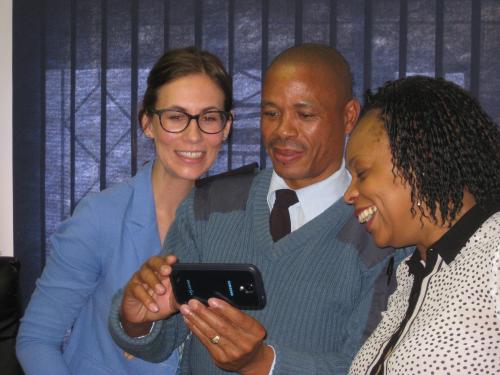 Stephanie, the police commander and Camille pose for a selfie