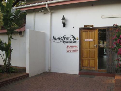 Photo of a building with a sign that says "Innisfree Apartments"