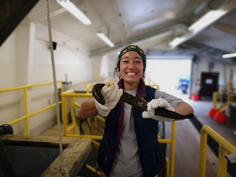 Photo of Samantha Ramirez holding a sea lamprey