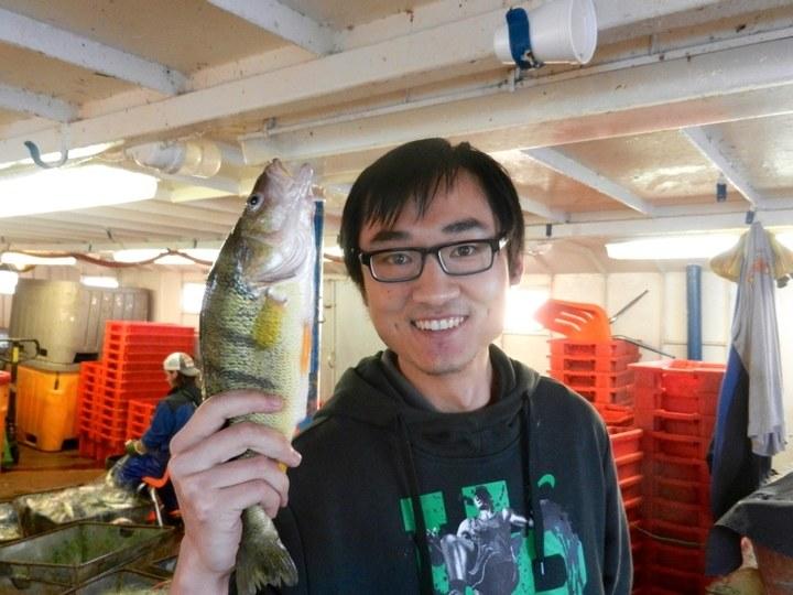 Dr. Fan Zhang holding yellow perch