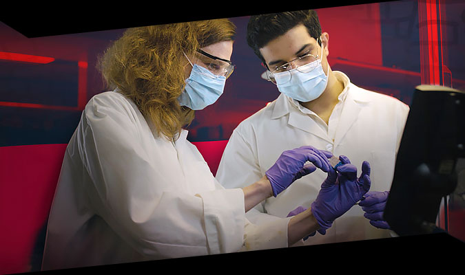 student and teacher working in lab