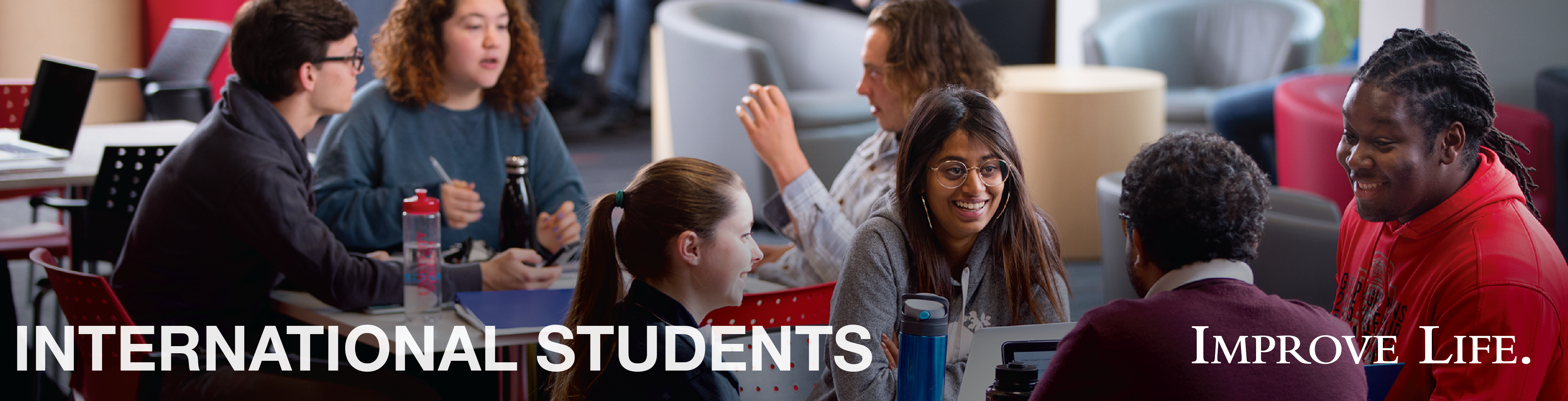 A group of students sit and talk.