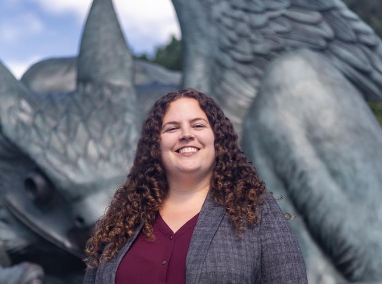 Caitling smiling in front of the Guelph Gryphon Statue