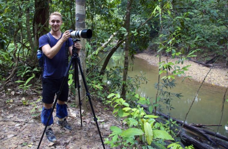 David Borish with camera in jungle