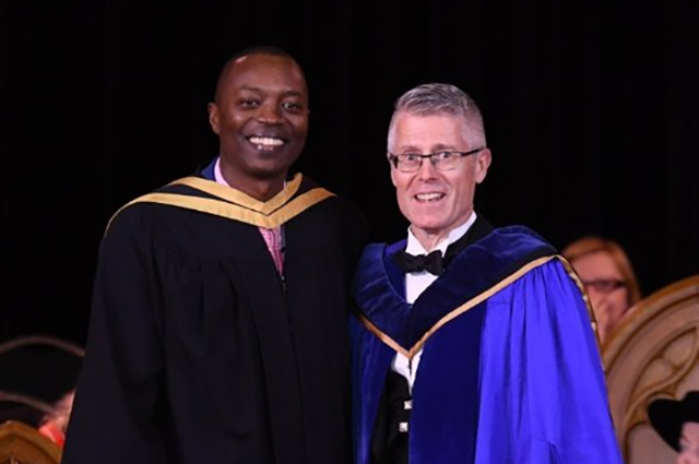 Amani Hitimana (L) with Malcolm Campbell, VP of Research at the University of Guelph (R)