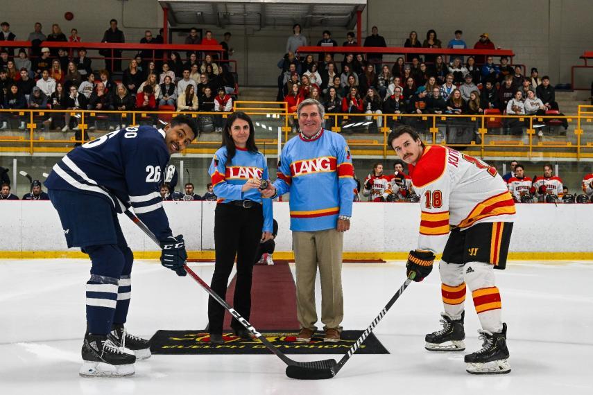 Audrey Jamal and Stu Lang with two hockey players.