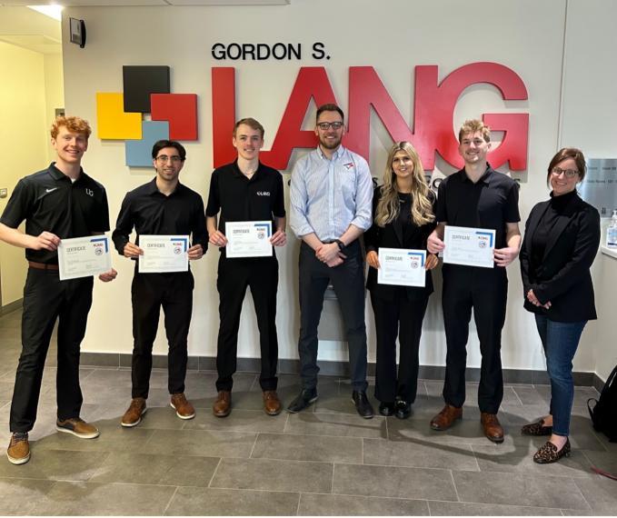 Lang students accepting top honours for the 2nd Annual Lang x Toronto Blue Jays Sport Sales Pitch Competition. From left: Tim Blackmore, Nick D’Agostino, Scott Vanos, Tom Zapletal, Morgan Lunney, Tristan Elkin, and Katie Lebel.
