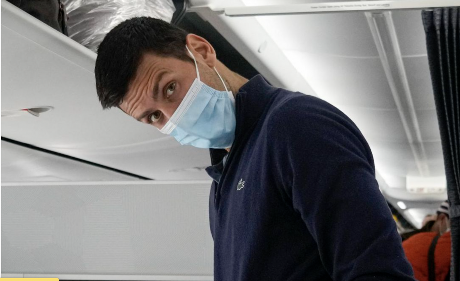 Novak Djokovic preparing to take his seat on a plane.