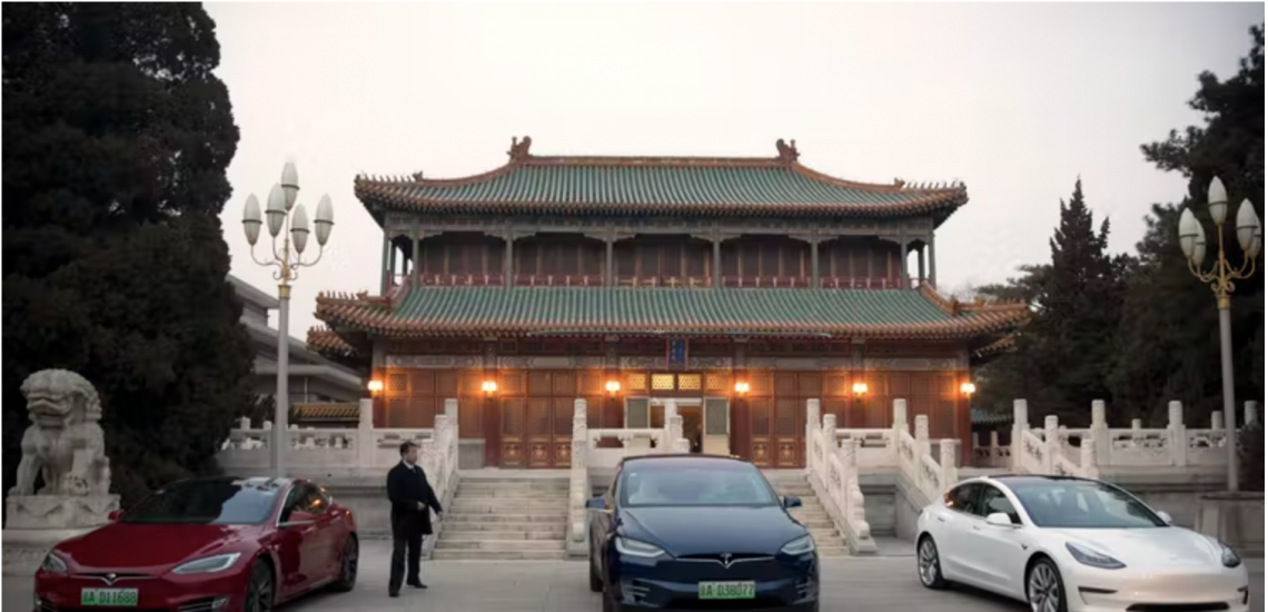 Tesla vehicles are parked outside of a building during a meeting between Tesla CEO Elon Musk and Chinese Premier Li Keqiang in Beijing in 2019.
