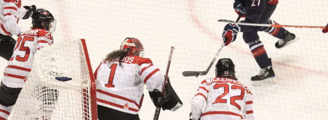 Women playing hockey.