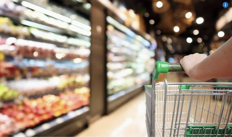 Grocery store with someone pushing a cart.