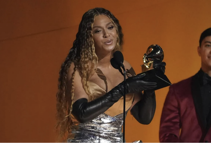 Beyonce holding a Grammy award.