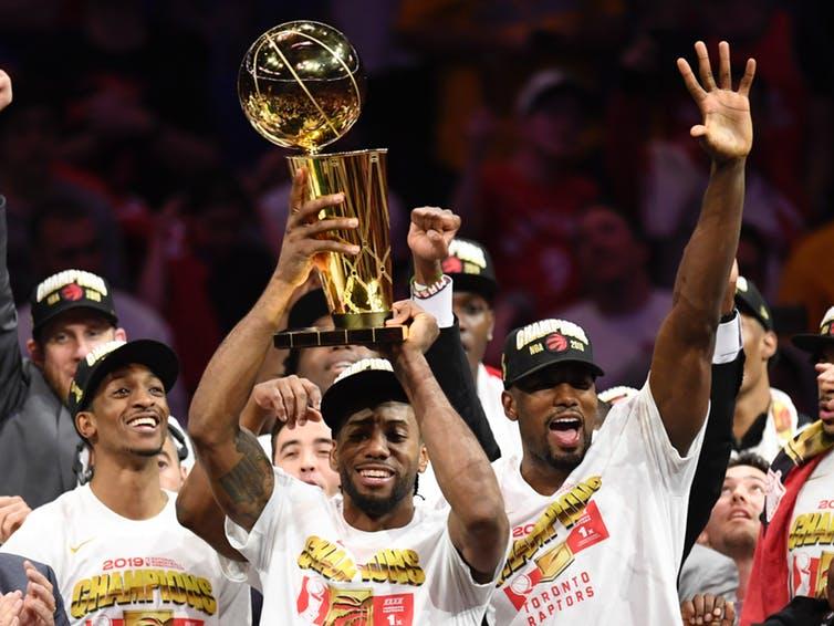 Raptors winning the NBA championship, holding trophy