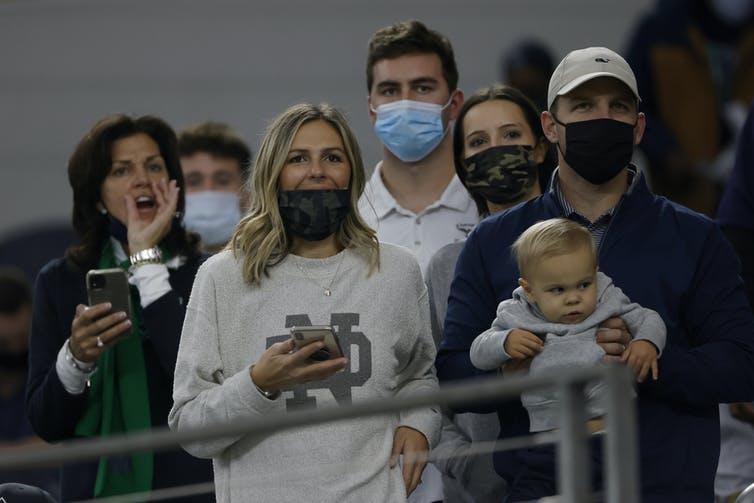 Fans watch warmups before the Rose Bowl NCAA college football game between Notre Dame and Alabama, in Arlington, Texas, on Jan. 1. 2021