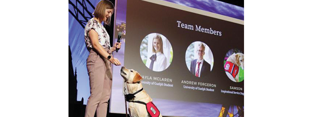 Student with guide dog on stage