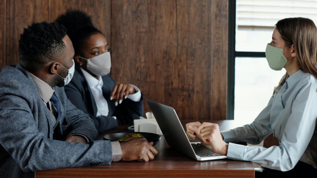 Coworkers wear face masks at work