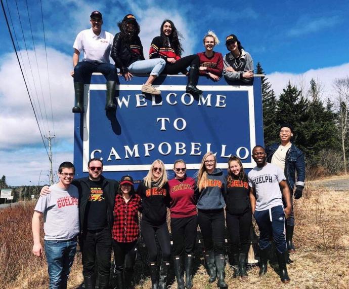 Lang business students in front of Campobello Island sign