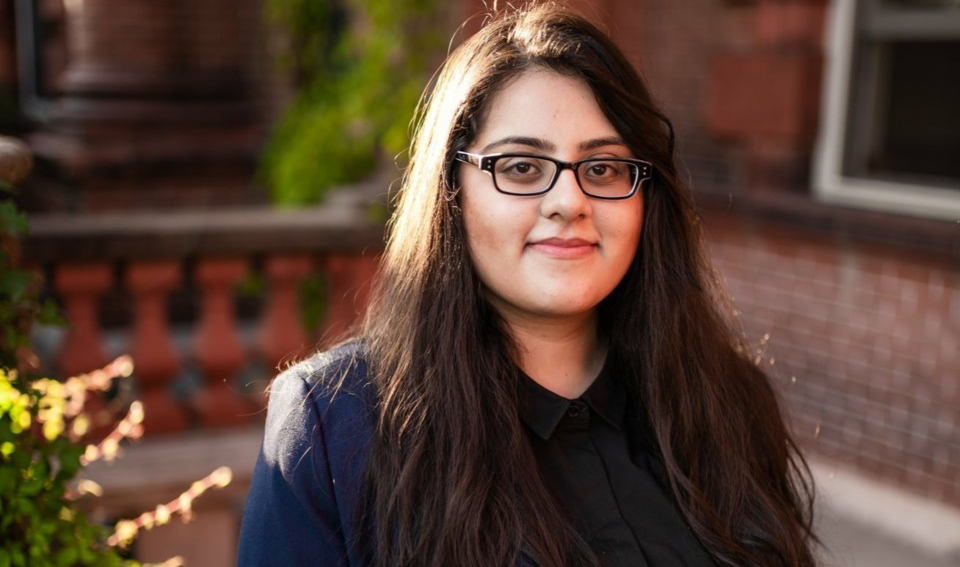 Nabeeha standing in front of a building on campus