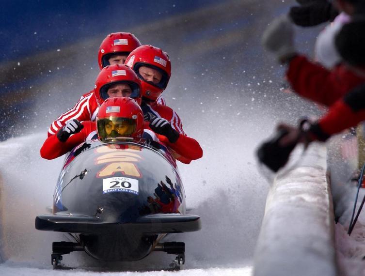 bobsledders racing down a track