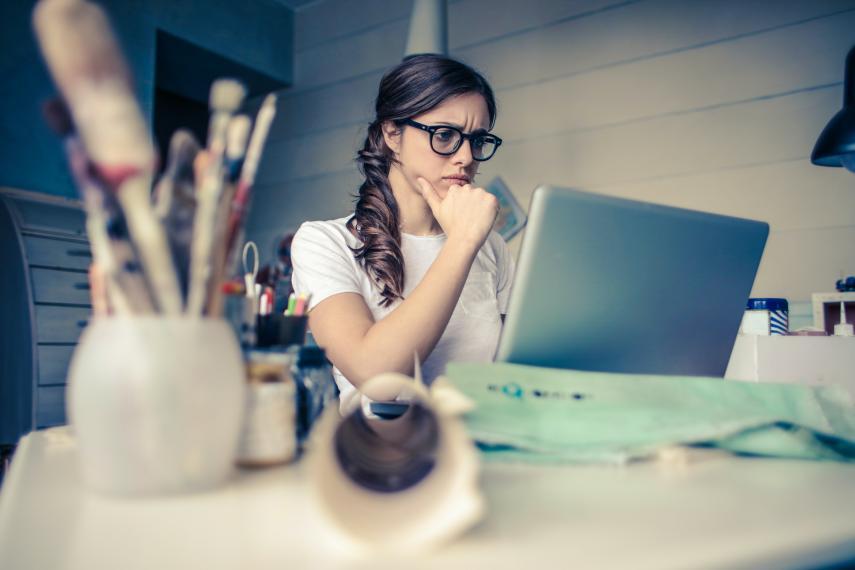 photo of women looking stressed while on her computer