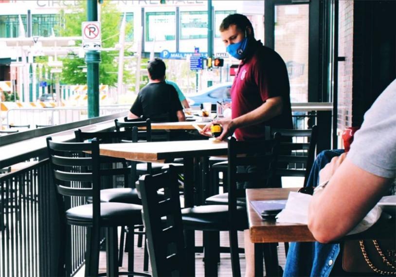 photo of restaurant staff member measuring table distances