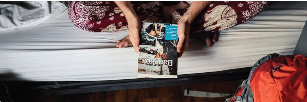 women holding a travel brochure