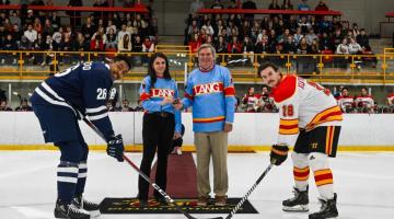 Audrey Jamal and Stu Lang with two hockey players.