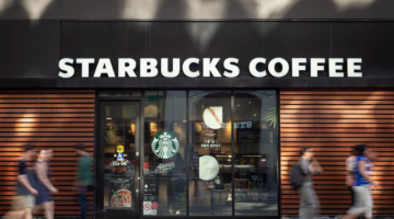 People walking in front of Starbucks Coffee.