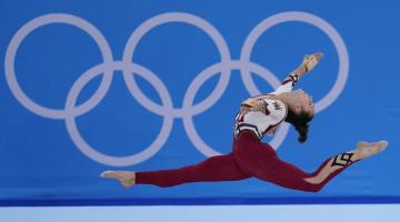 Female gymnast in the air at the Tokyo 2020 Olympic Games