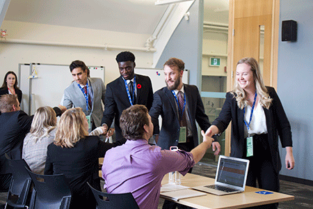 Students shaking hands with judges