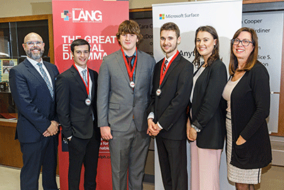 Judges posing with students and their medals