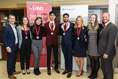 Judges posing with students and their medals