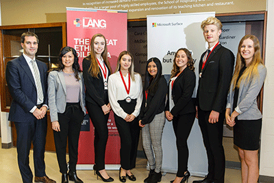 Judges posing with students and their medals