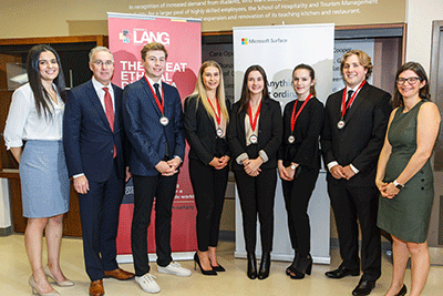 Judges posing with students and their medals