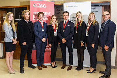 Judges posing with students and their medals