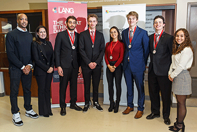 Judges posing with students and their medals