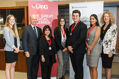 Judges posing with students and their medals