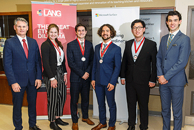 Judges posing with students and their medals