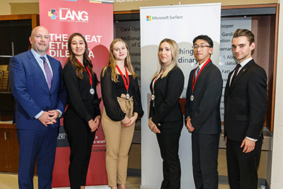 Judges posing with students and their medals