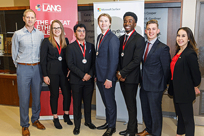 Judges posing with students and their medals