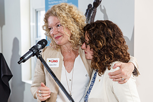 Statia Elliot and Julia Christensen Hughes hugging