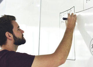 entrepreneur drawing on a whiteboard