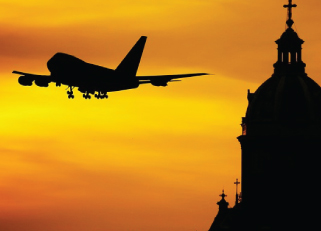 a plane taking off in a sunset