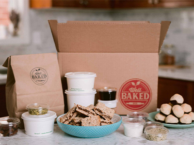 Baked goods sitting on the counter with a box in the background that has the Well Baked Box logo on it.