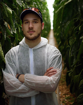 Dylan Sher in crop field